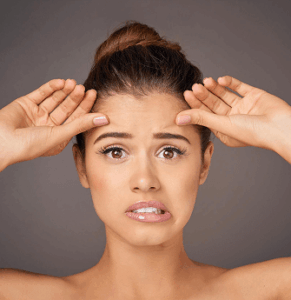 a woman with wierd expression due to thread lift treatment going wrong