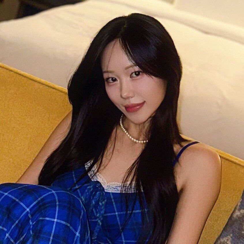 a korean woman in blue dress sitting on a couch
