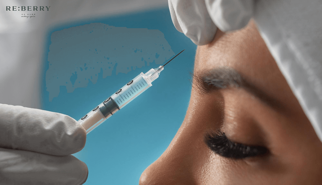 doctor giving botox injection in forehead of woman