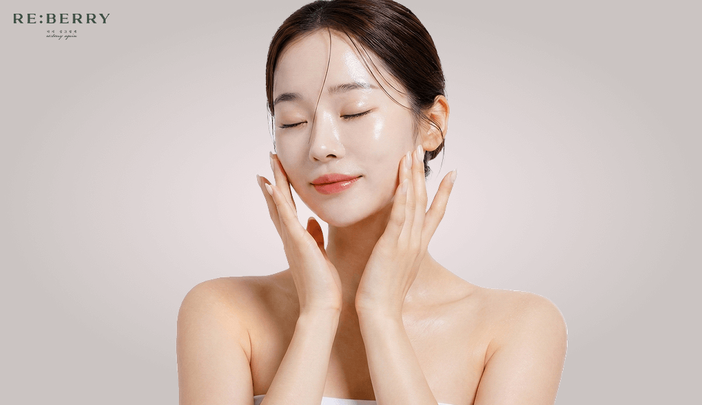 a woman with fresh skin touching face with both hands closing the eyes