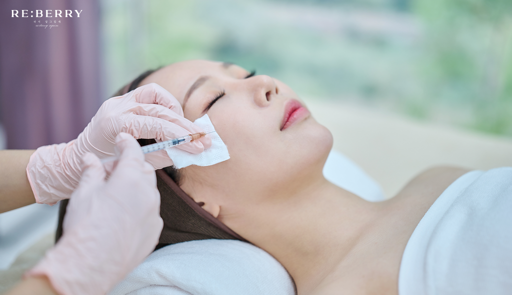 a girl lying on bed getting botox injection treatment