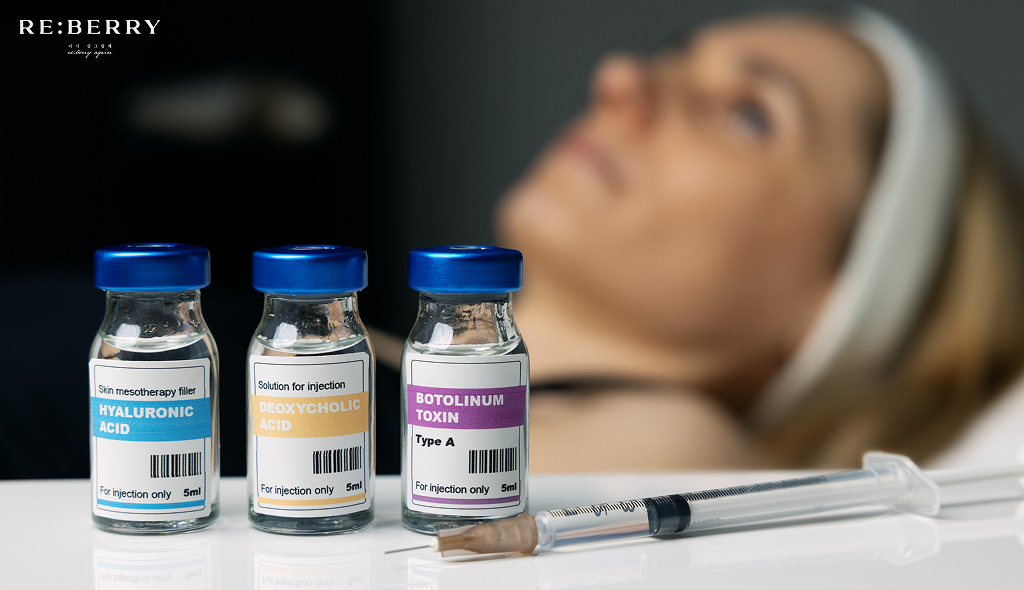 three glass bottles of botulinum toxin with an injection and a female patient behind