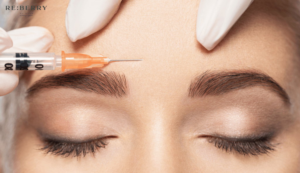 a woman getting botox injection on forehead