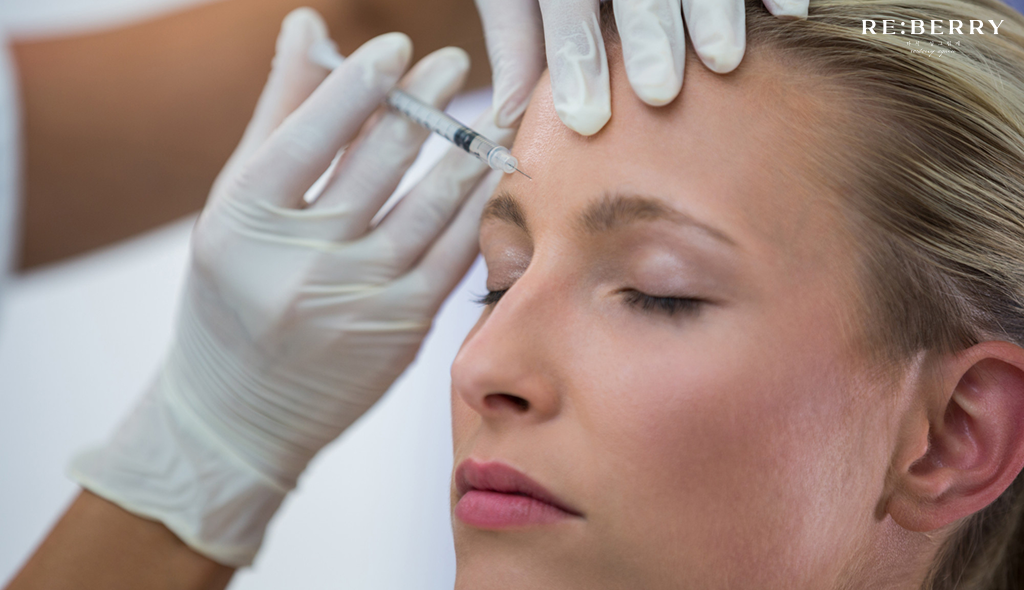 Dermatologist administering Botox injection to a patient's forehead at a clinic