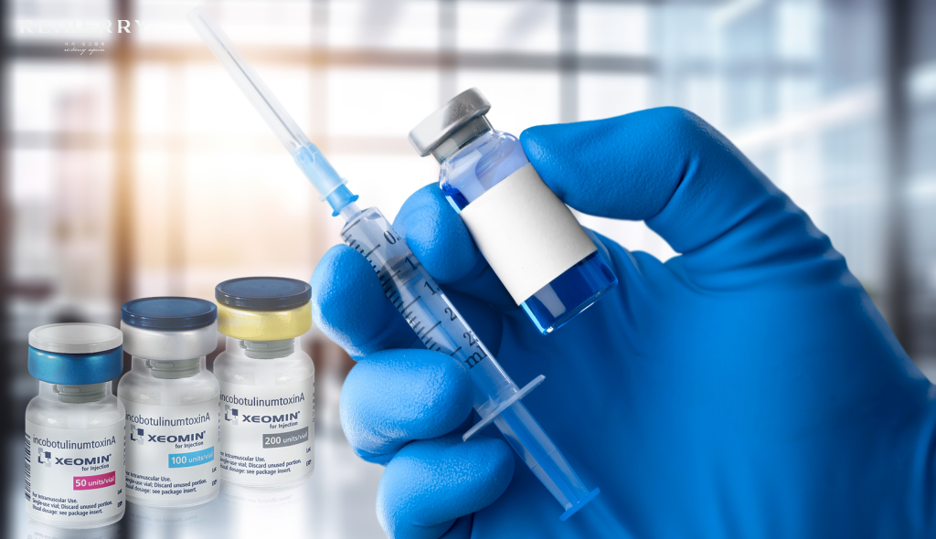 A gloved hand holding a syringe next to botulinum toxin vials