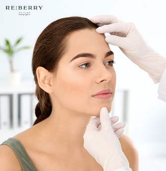 a dermatologist evaluating facial issue of patient during appointment