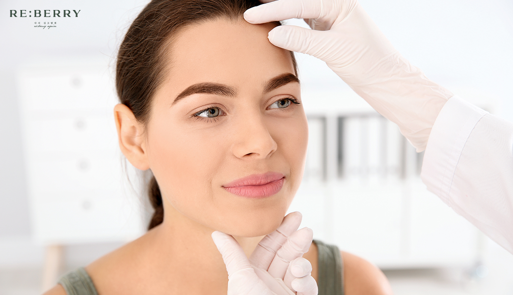 a dermatologist checking face of patient during botox appointment