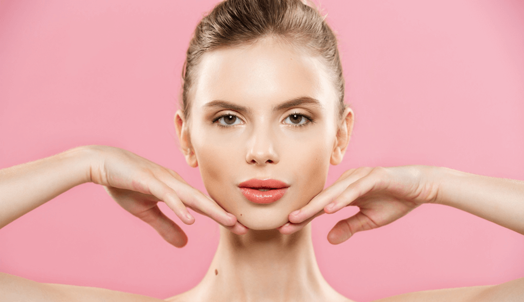 a woman with hands under chin looking forward